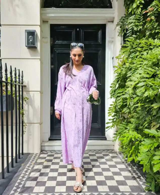 Woman in a long, light purple dress.